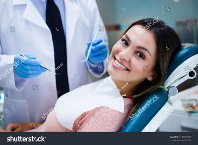 stock-photo-her-amazing-smile-beautiful-young-woman-looking-at-camera-with-smile-in-dentist-s-office-1197258550